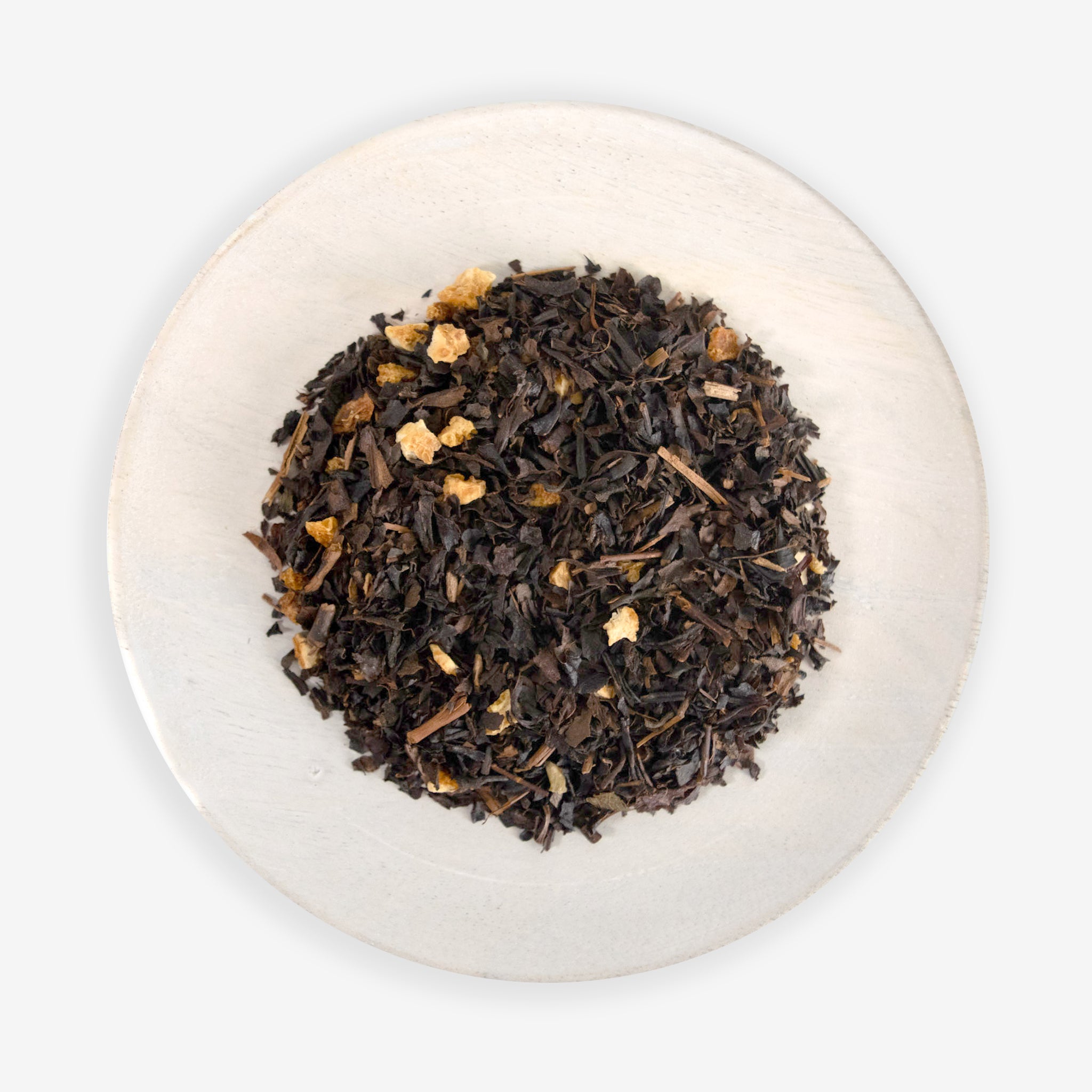 A top-down image of Citrus Oolong tea leaves mixed with pieces of orange peel, against a white background.